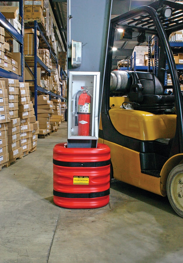 Red mini column protector beneath mounted fire extinguisher