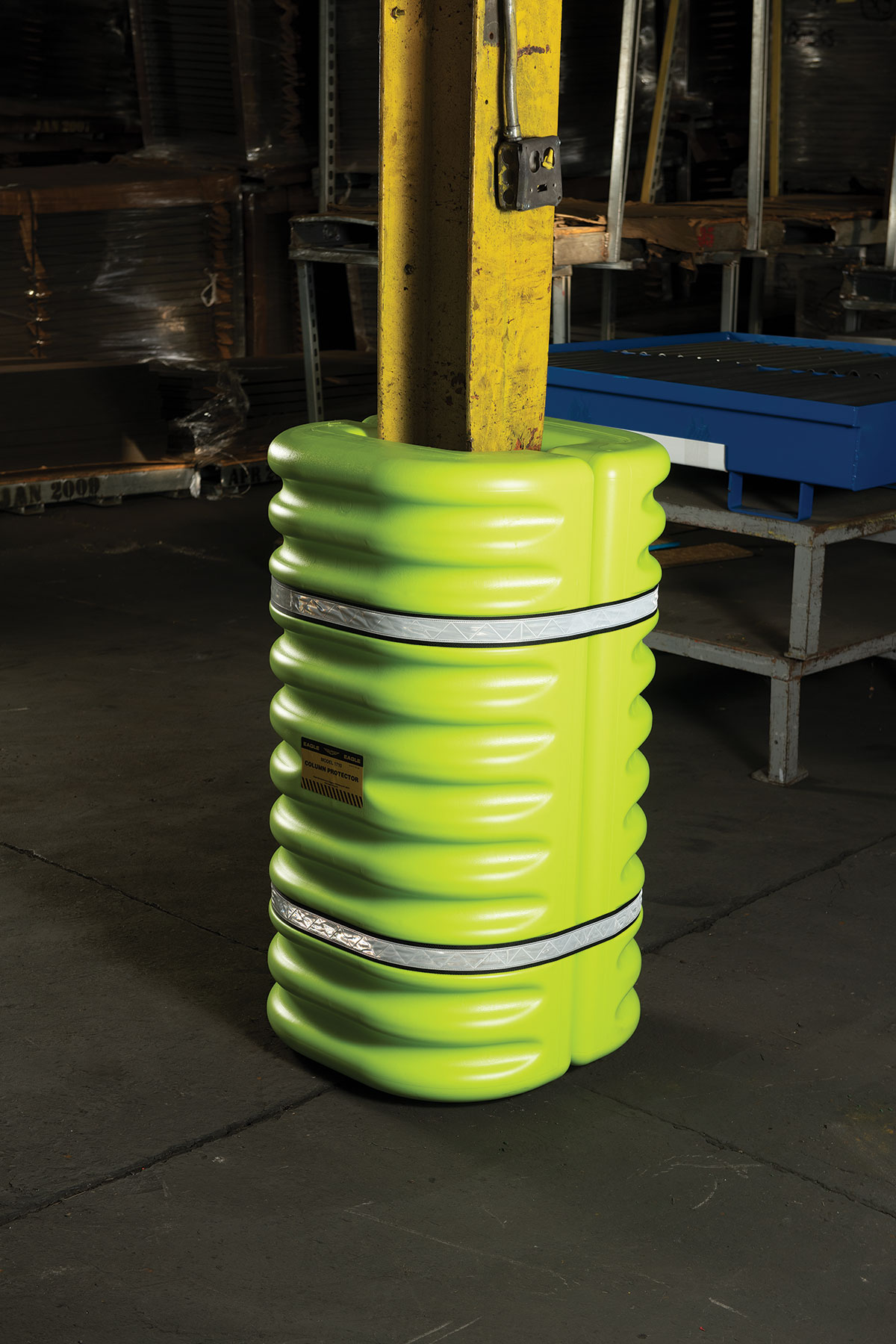 Red mini column protector beneath mounted fire extinguisher