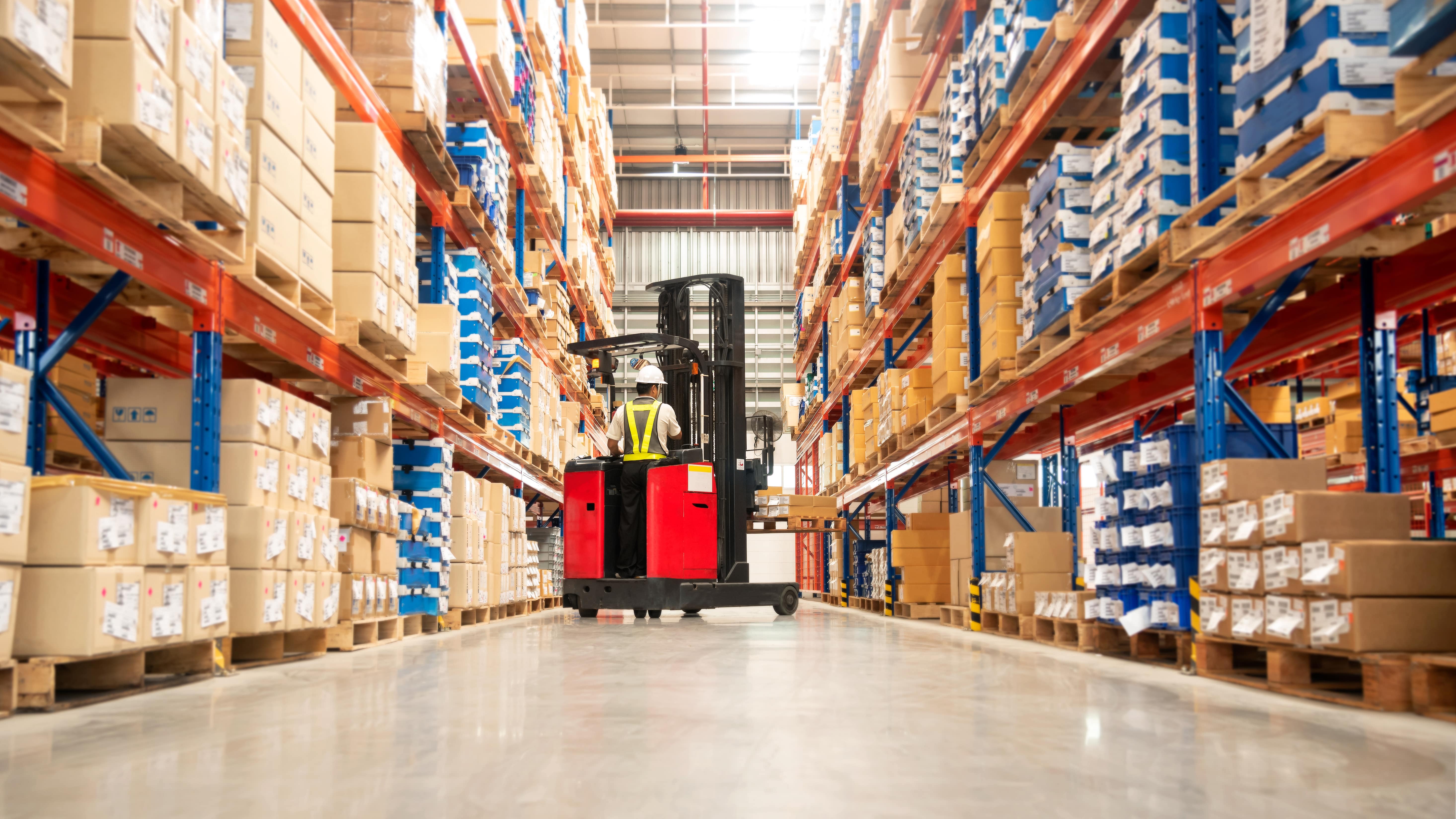 Forklift in aisle at large distribution center